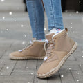 A pair of black outdoor snow boots with a lace-up front and a round toe on a non-slip rubber sole.
