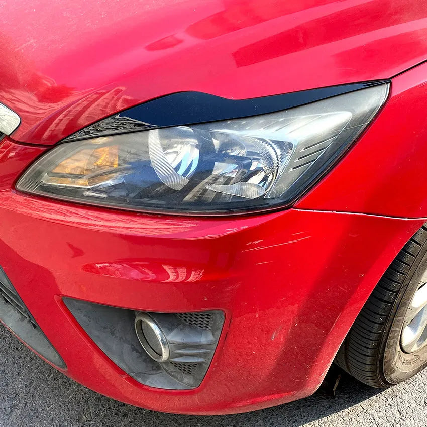 Pair of ABS plastic headlight eyebrow stickers for Ford Focus in carbon fibre pattern and piano black finish