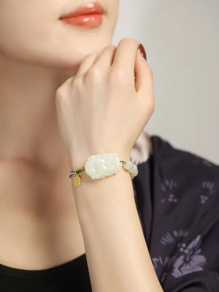 Hetian Jade Chinese zodiac bracelet on red cotton rope with S925 silver card for Year of Rabbit.