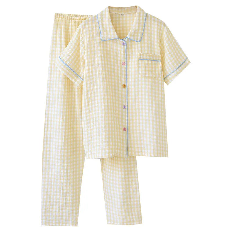 Young woman wearing a loose yellow plaid cotton gauze short-sleeved trousers suit.