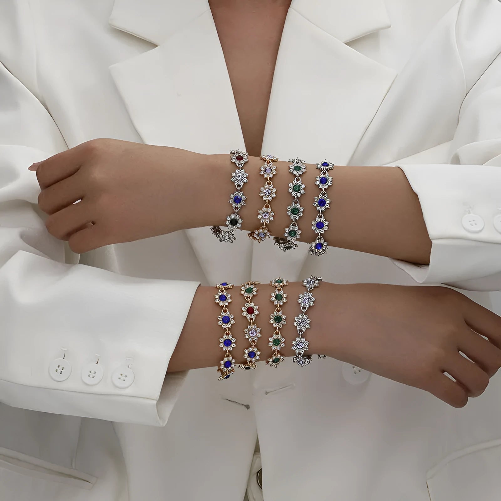 European style electroplated bracelet with flower-shaped coloured gemstones on a metallic chain.