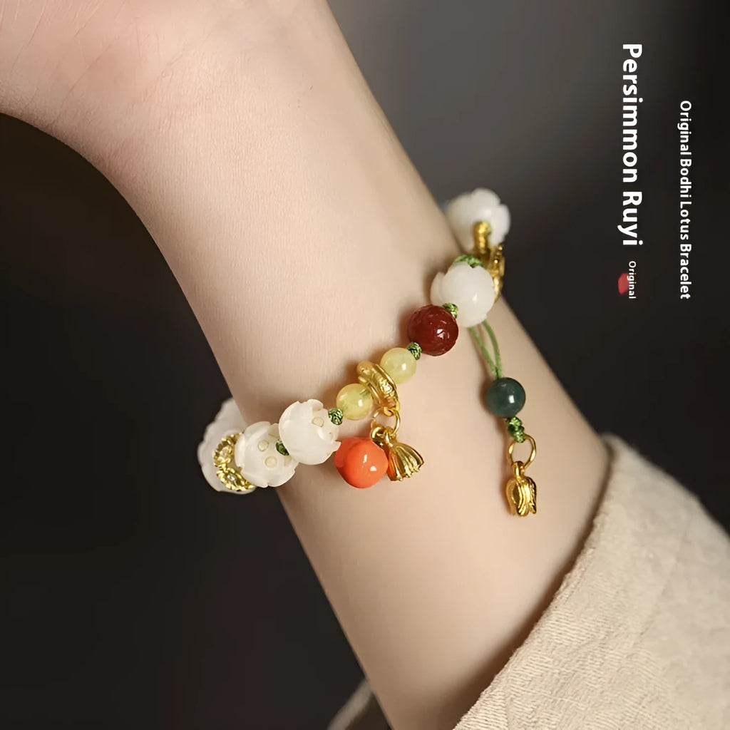 White jade Bodhi bracelet with lotus beads and a large pumpkin bead on an open rope.