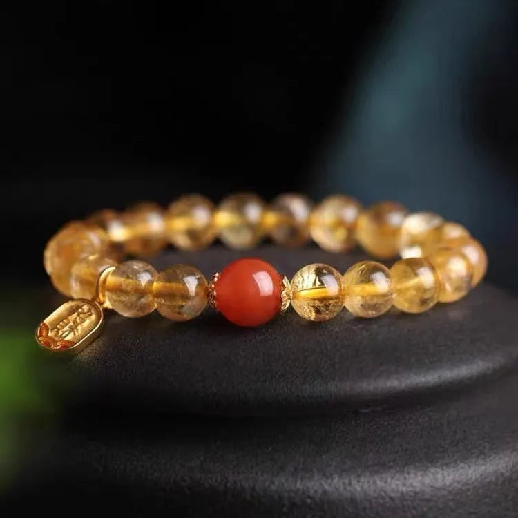 Red agate bracelet with gold ruby accents showing three bead size options on wrist