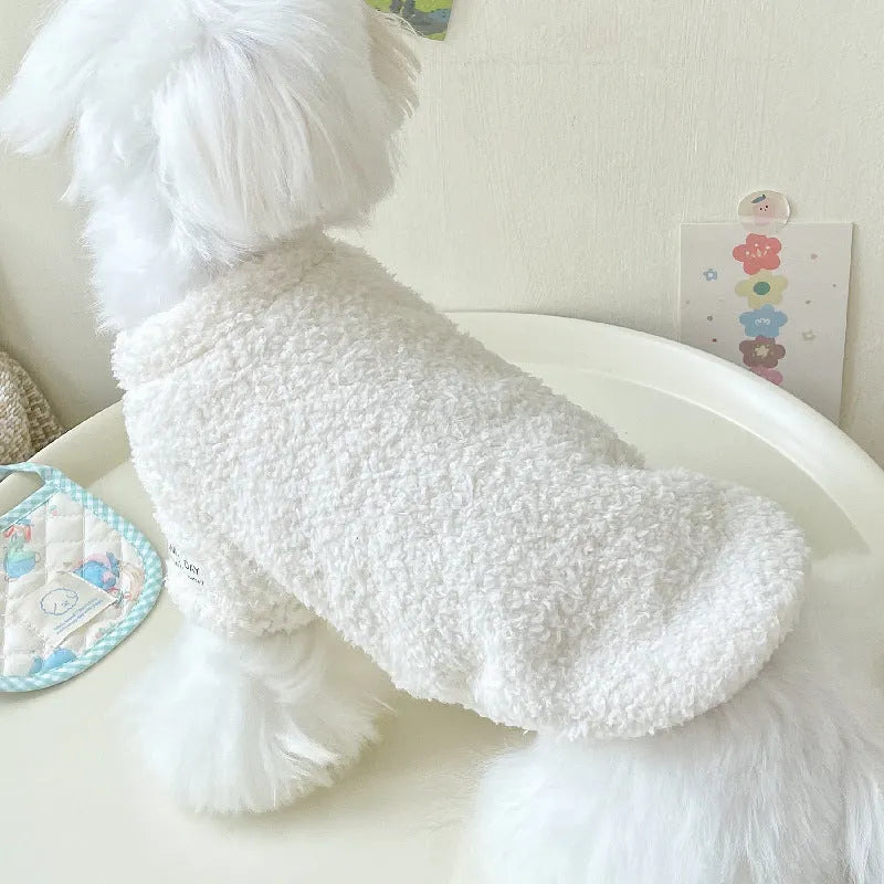 Reversible brown cloud velvet dog jacket shown on a small dog, illustrating the fluffy texture and fit.