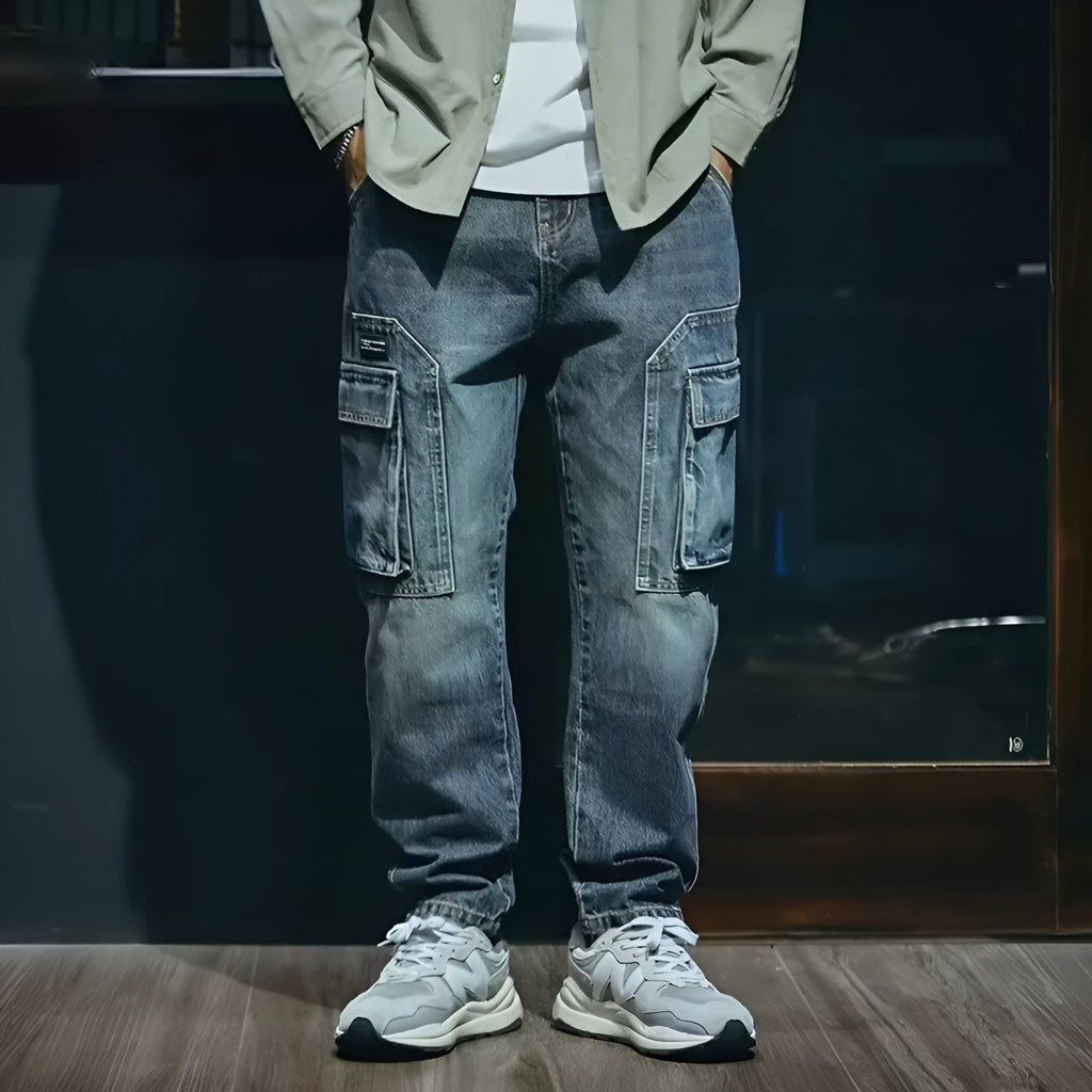 Man wearing blue loose straight leg stretch jeans in a casual setting