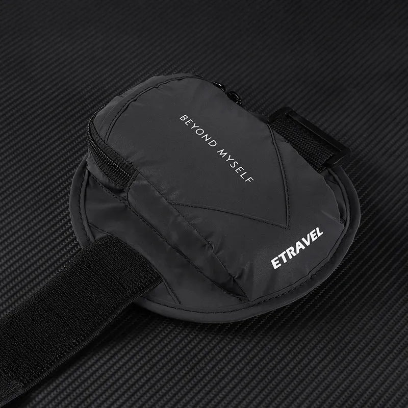 Black reflective running arm band wrapped around an arm, showing its strap and phone compartment.