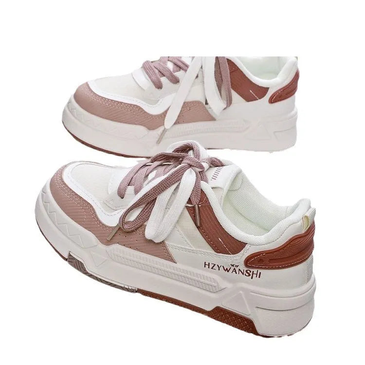 Children's beige board shoes with cross straps, thick rubber sole, and lace-up front.