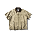 A loose grey or khaki cotton short-sleeved overall shirt, shown as an oversized cardigan style.