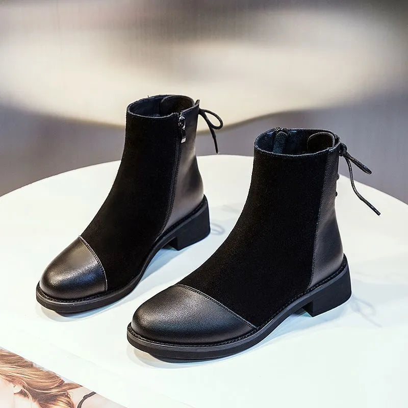 Black women's knee-high Martin boots with side zip and round toe.