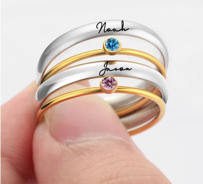 Geometric titanium steel ring with engraved detail and December birthstone colours on a white background
