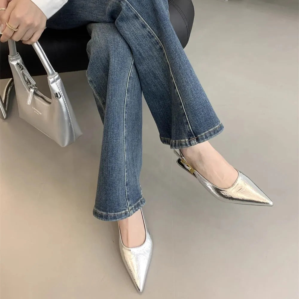 Thin low heel strap pointed leather shoes in black colour showing ankle strap and rubber sole