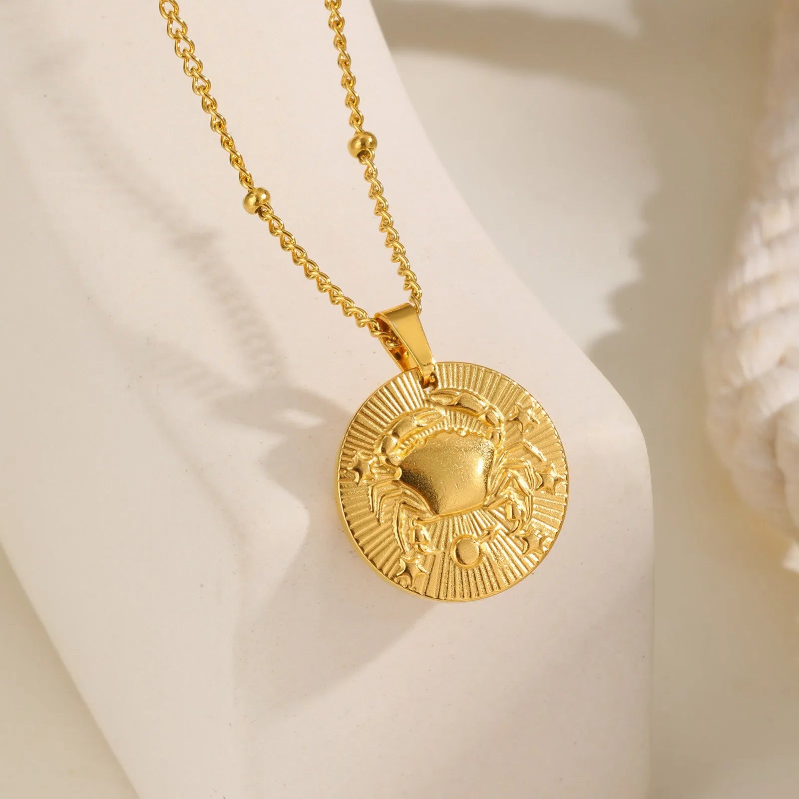 Stainless steel zodiac constellation bead necklace with embossed designs and cross chain