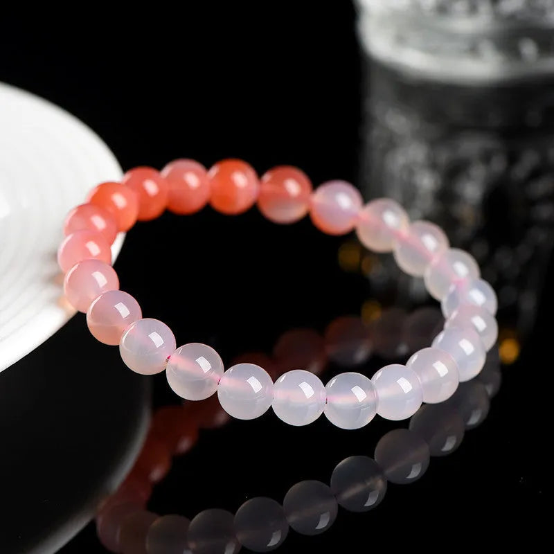 Natural gradient Yanyuan agate bracelet with geometric beads on a wrist.