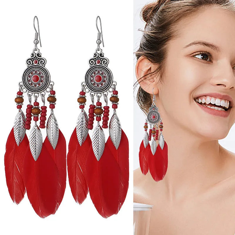 Round drop feather earrings with alloy construction and patterned design in various colour options