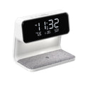 White 3-in-1 bedside lamp with wireless charging pad, LCD clock screen, and fabric-effect ABS shade.