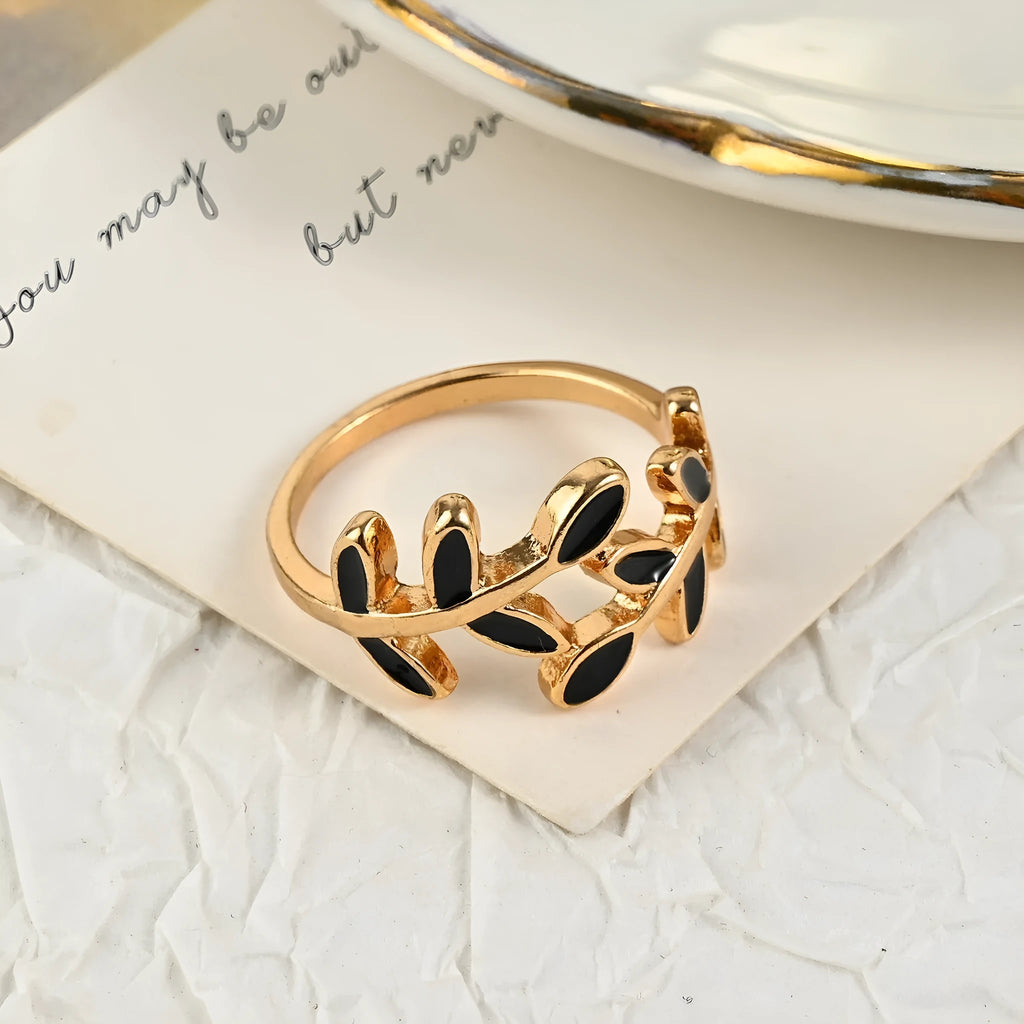 Gold geometric leaf design acrylic ring for women on a white background.