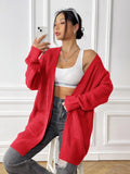 Women's dark green loose fit cardigan with two front pockets and long sleeves.
