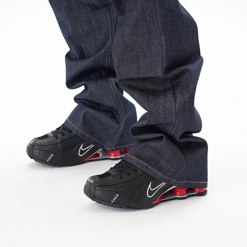 A pair of dark blue loose-fit straight leg jeans on a neutral background.