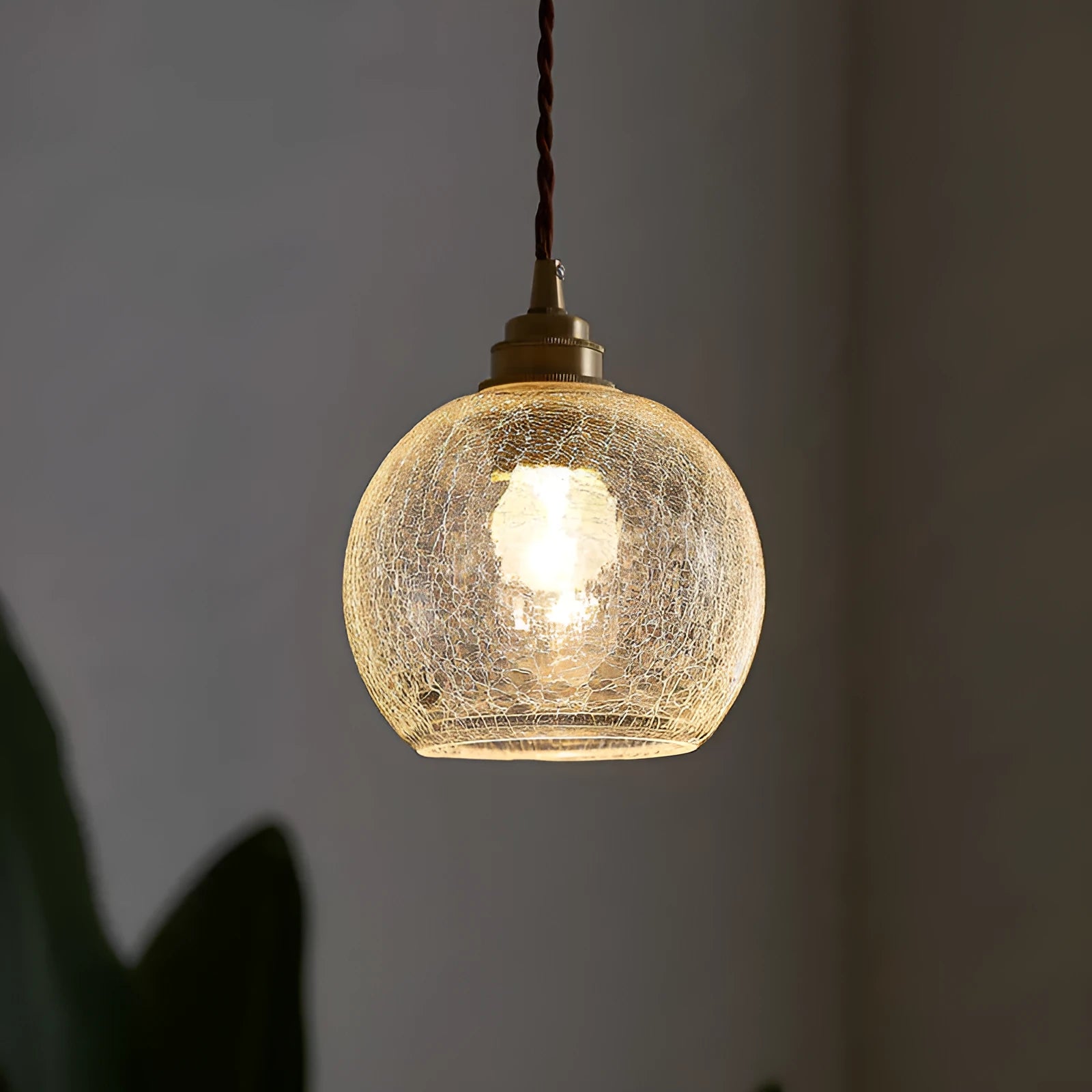 Brass and glass ball chandelier with spherical shade and metallic body
