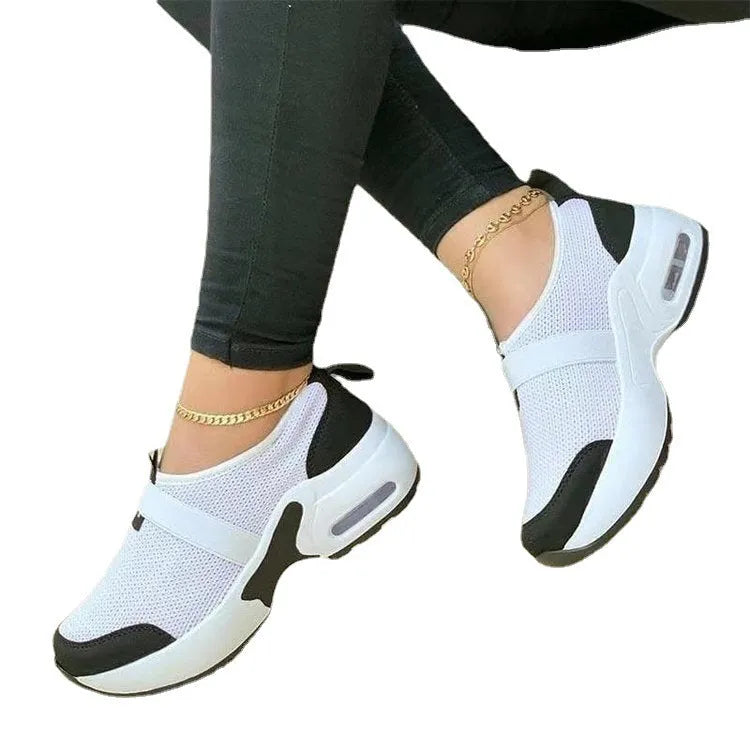 Women's white mesh flat sneakers with a round toe and rubber sole, shown alongside black, blue, and pink colour options.