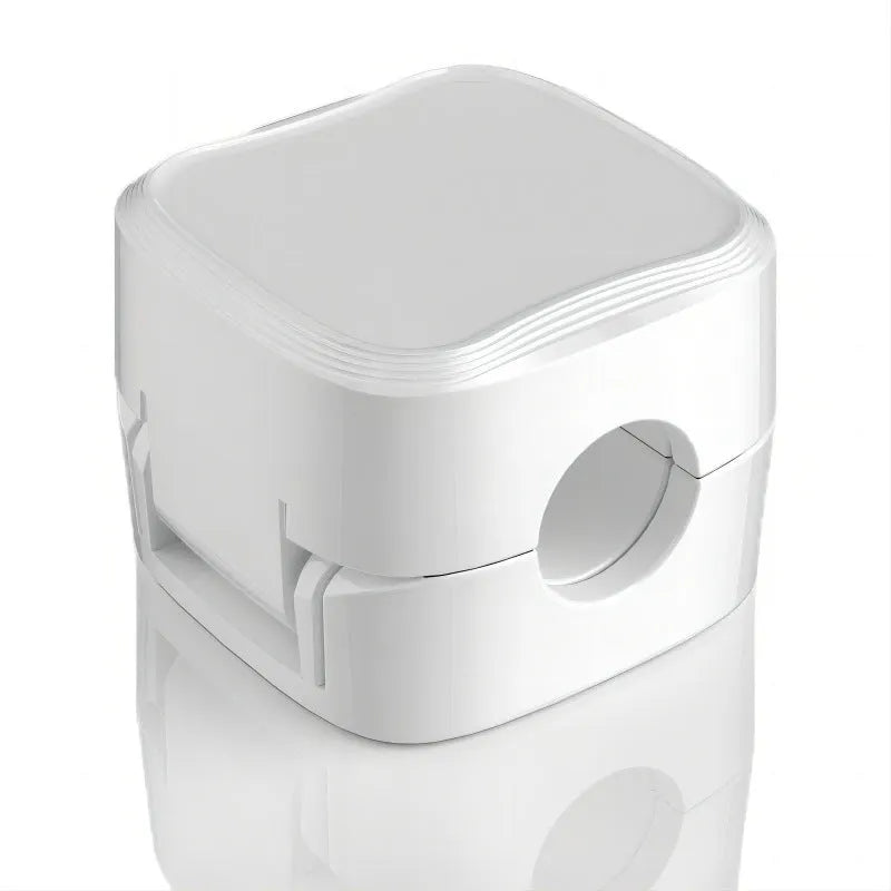 White and black magnetic cable clips with adhesive backing holding a USB cable against a wooden desk edge.