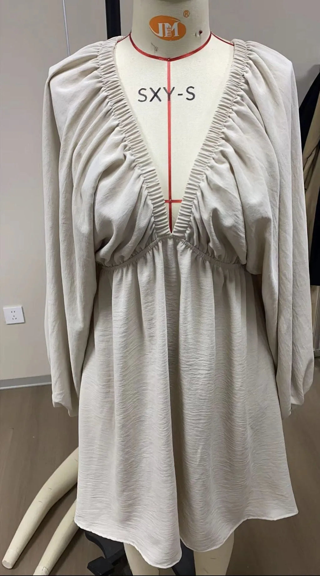 Women's apricot V-neck midi dress with long puff sleeves and a flounced skirt.