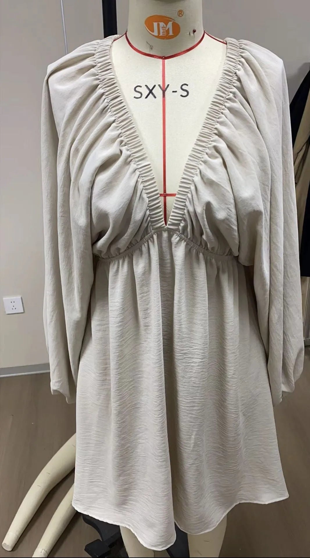 Women's apricot V-neck midi dress with long puff sleeves and a flounced skirt.
