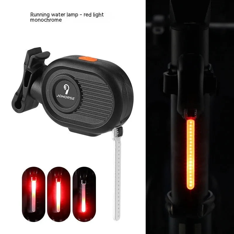 Bicycle taillight displaying a blue waterfall or running water light effect on a dark background.