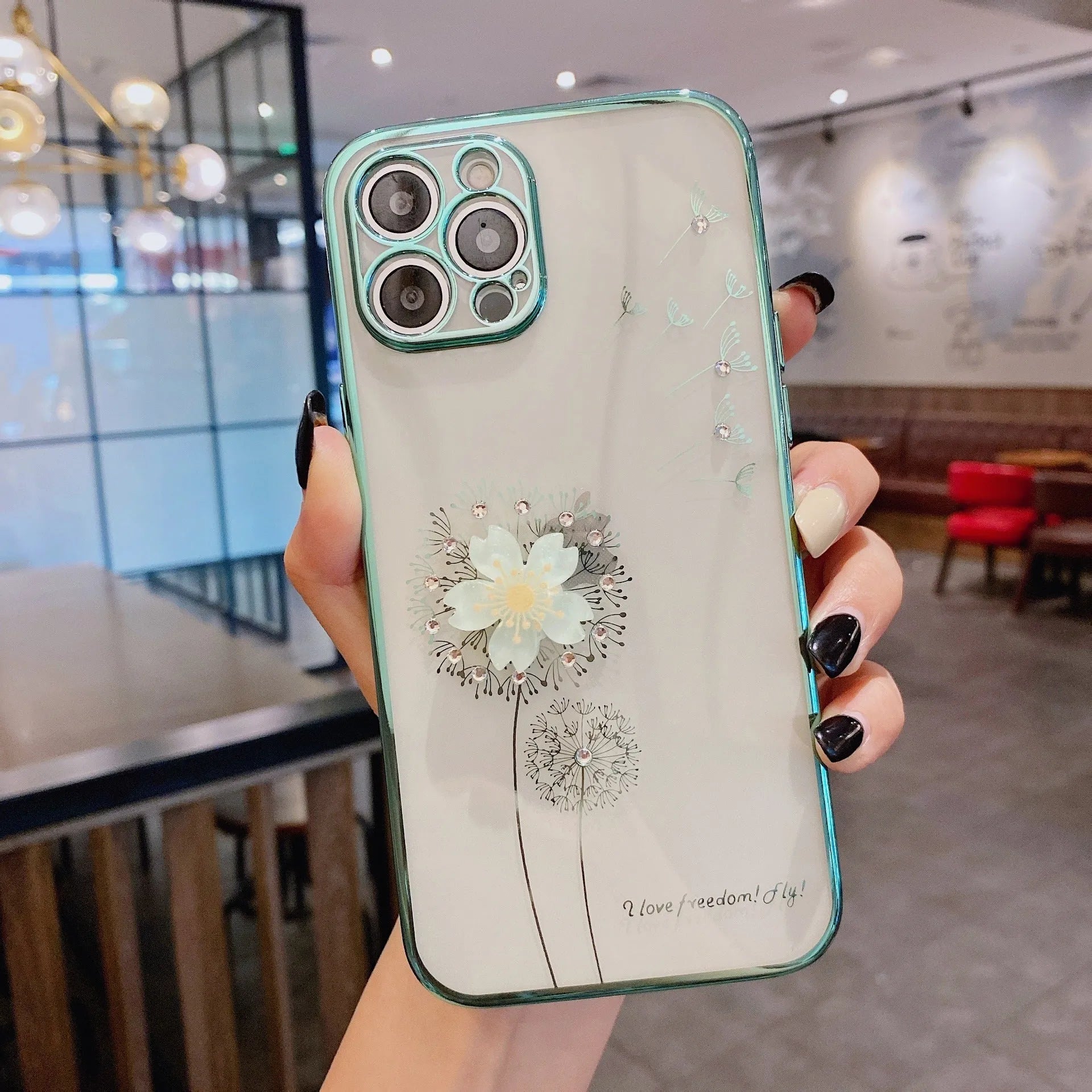 Green silicone iPhone case with a built-in screen protector and a white 3D flower spin stand on the back.