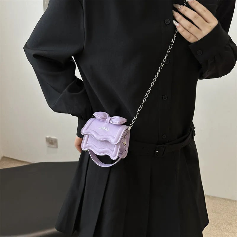 Small black PU leather crossbody bag for women with a single shoulder strap