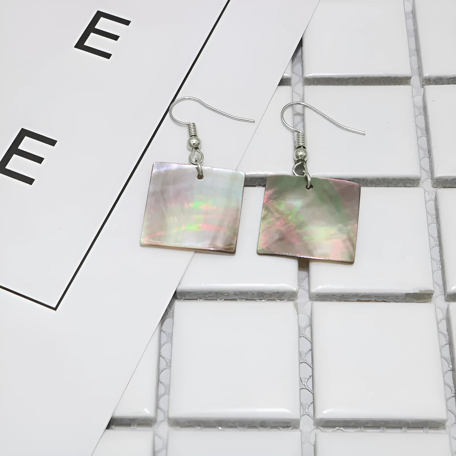 Women's shell geometric earrings with rectangular and square panther designs in natural shell material