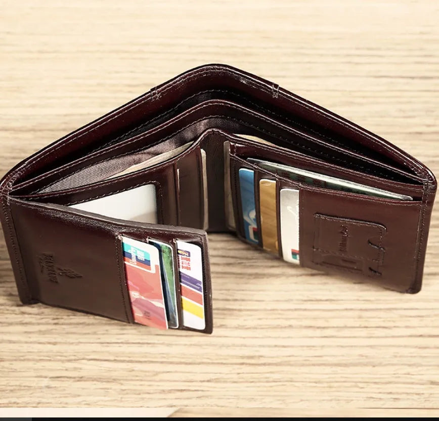 Men's brown leather bifold wallet open to show card slots, coin pocket, and banknote compartment.