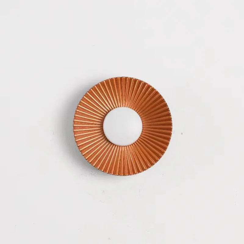 Round wall lamp with an aluminium shade and dimmable LED bulb in a white and gold colour finish.