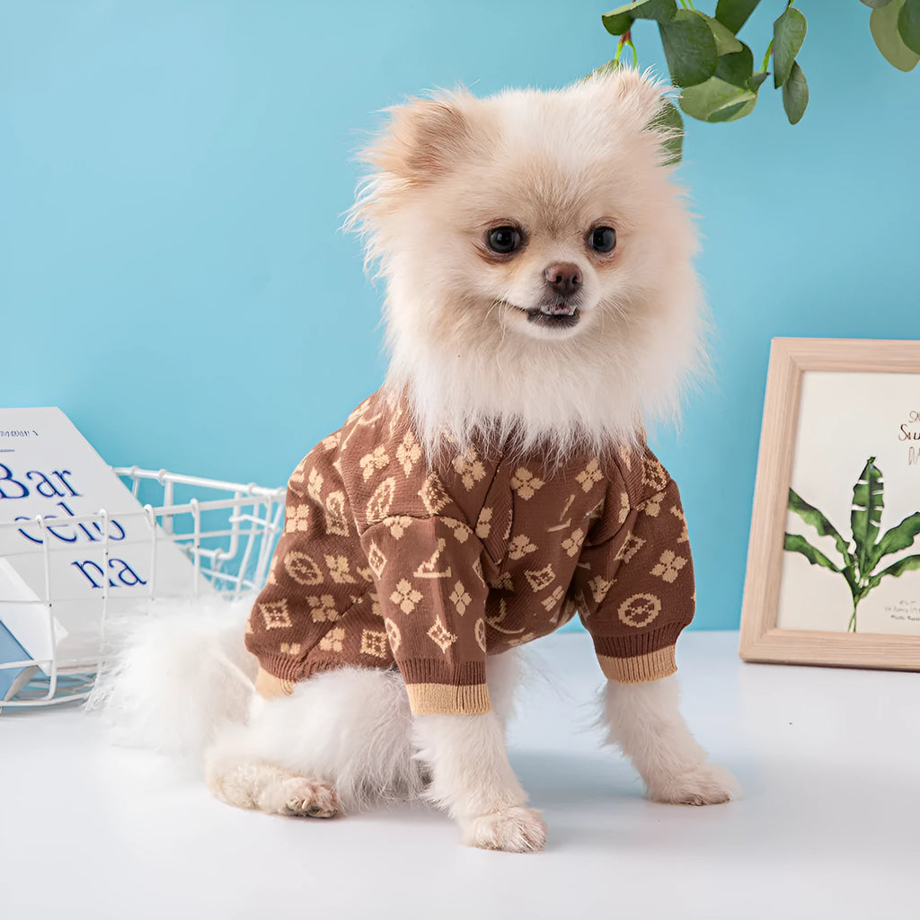 A dog wearing a thick, knitted wool sweater in a choice of monochrome or two-tone colours.