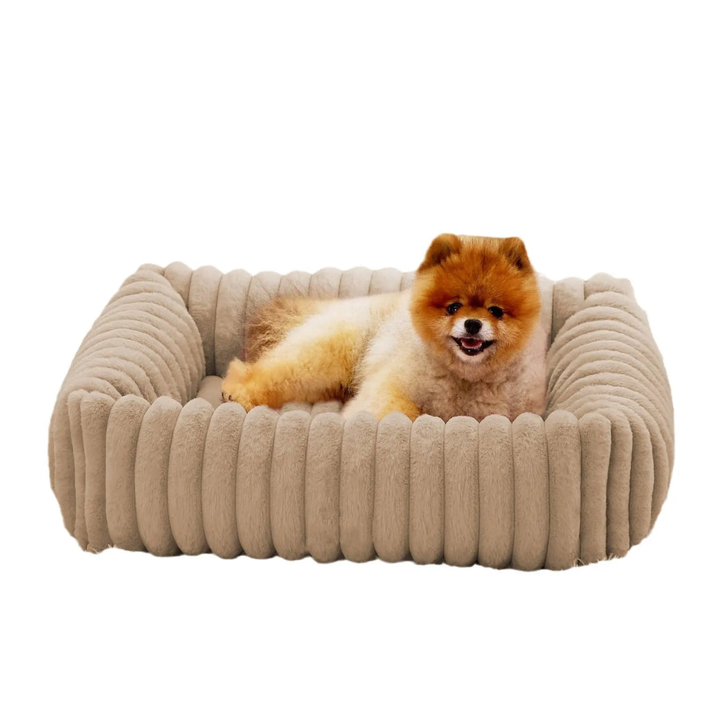 Grey pet bed with raised cushioned sides for a cat or dog.