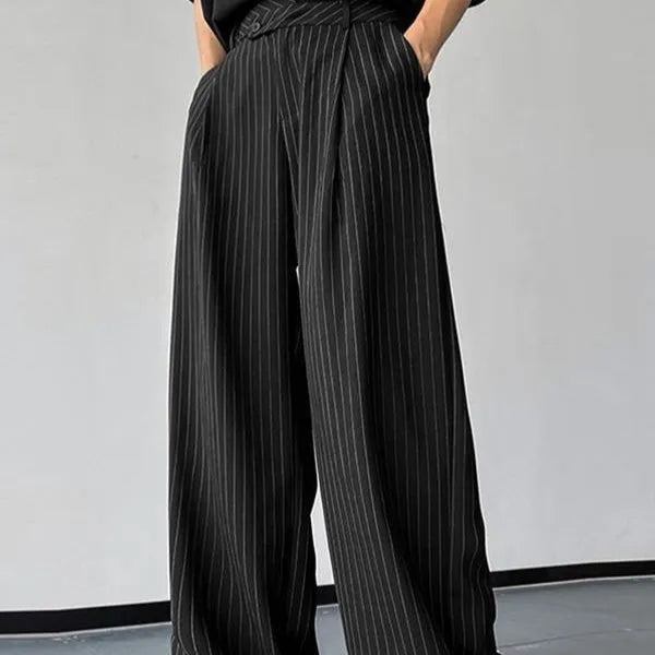 Men's black vertical striped pleated casual trousers showing elastic construction detail