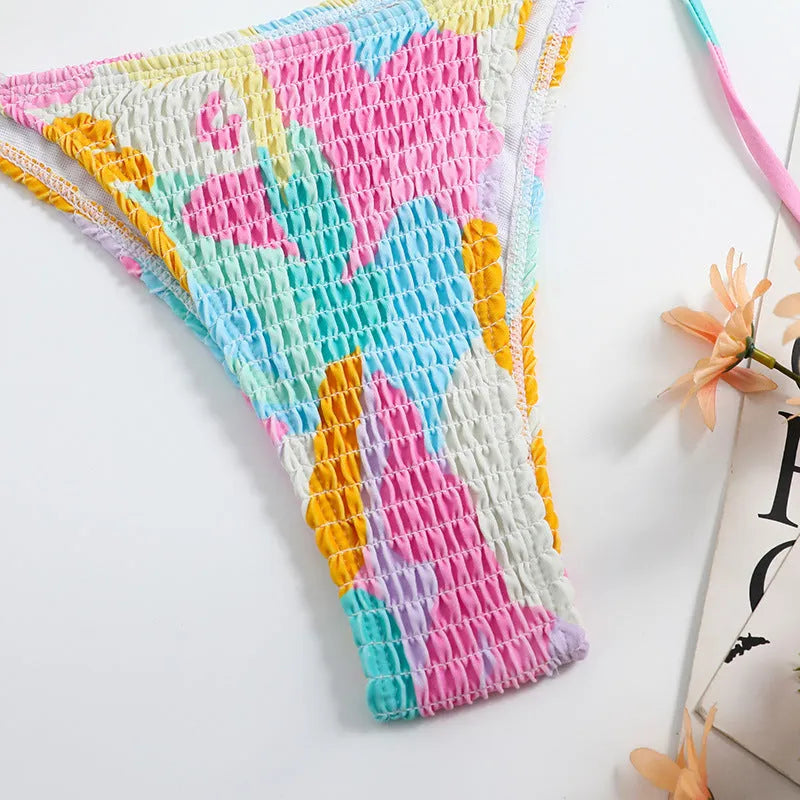 Women's floral print triangle bikini with smocking detail on the briefs, shown in multicolour.