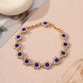 European style electroplated bracelet with flower-shaped coloured gemstones on a metallic chain.