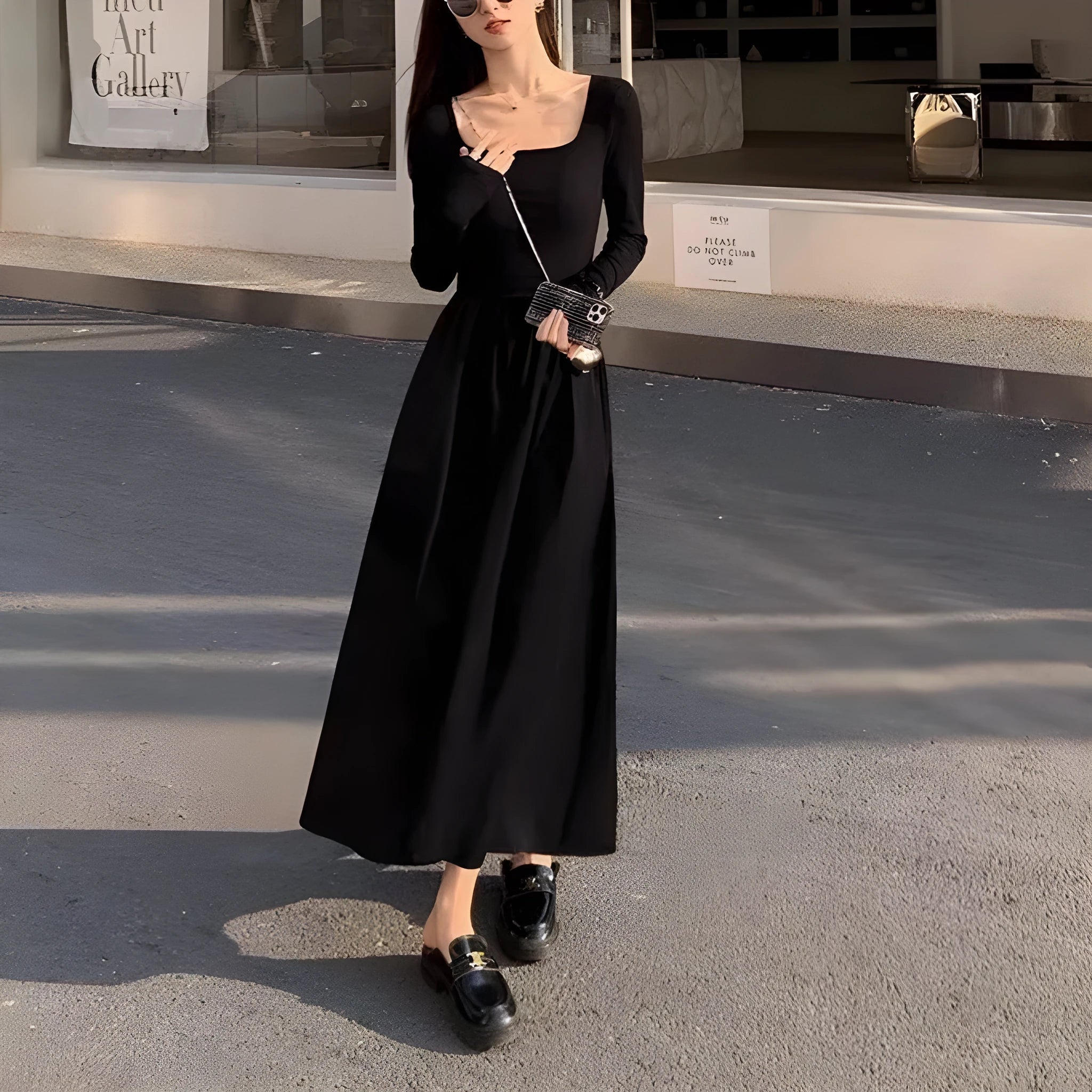 Women's black square collar knitted dress with long sleeves, elastic waist, and A-line long skirt.