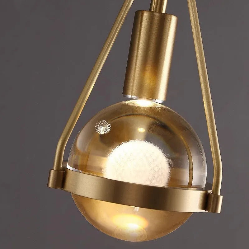 Modern copper and crystal chandelier with multiple light heads in a minimalist design.