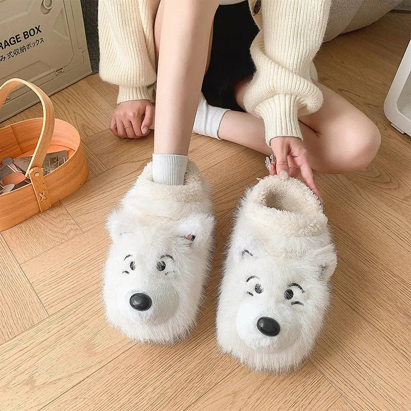 Grey ankle wrap slippers with a plush upper and a non-slip rubber sole, shown on a wooden floor.