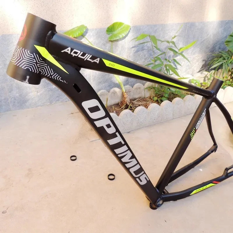 Black green aluminium mountain bike frame for 29-inch wheels with disc brake mount and internal cable routing ports.