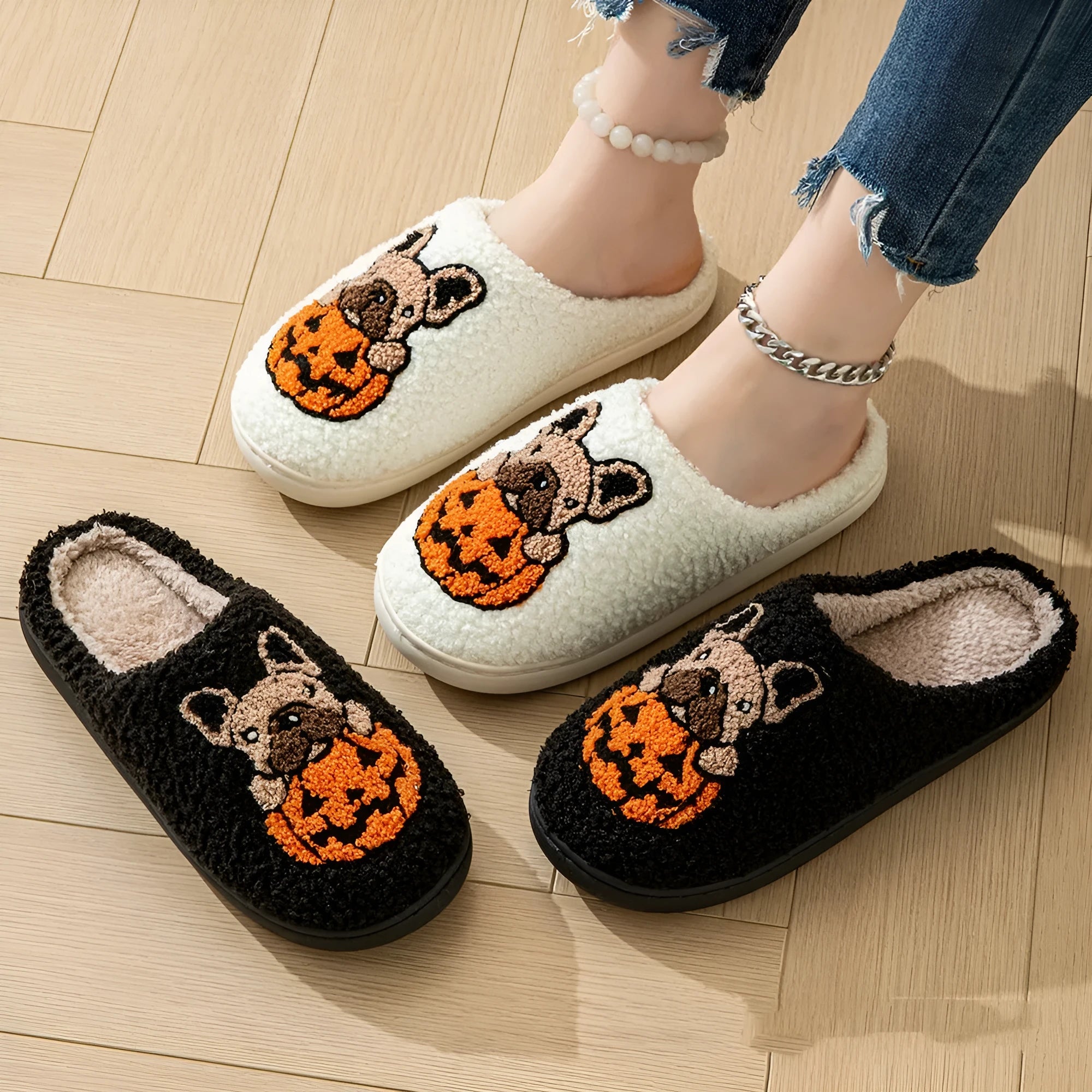 Black and white Halloween plush slippers with pumpkin design and non-slip rubber soles