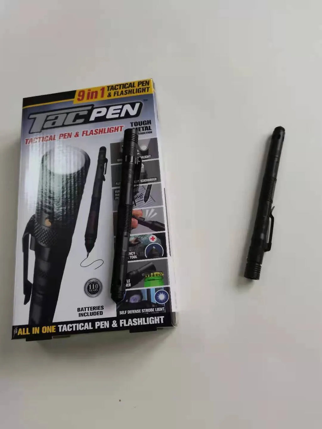 Nine-in-one multi-function flashlight survival pen in black with dual light sources and car window breaker