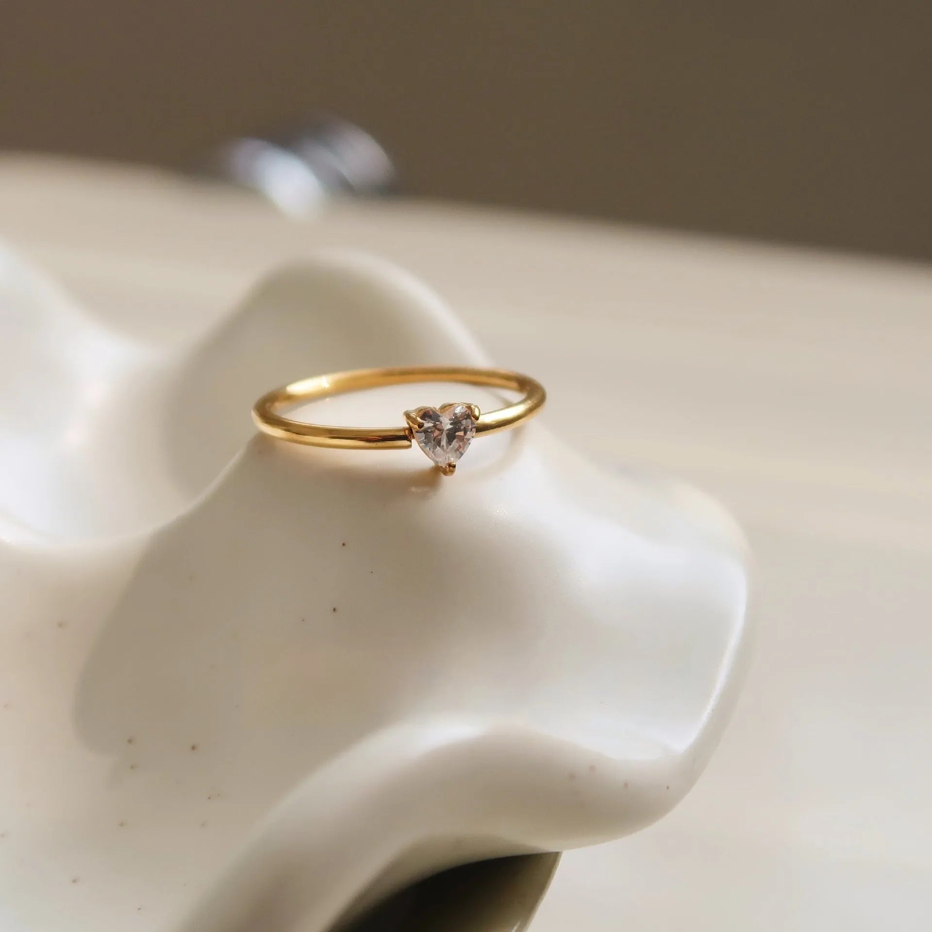 Golden electroplated stainless steel love heart ring for women showing heart shape.