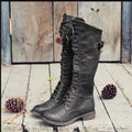 Women's black chunky heel high leg boots with a round toe and low heel on a plain background.
