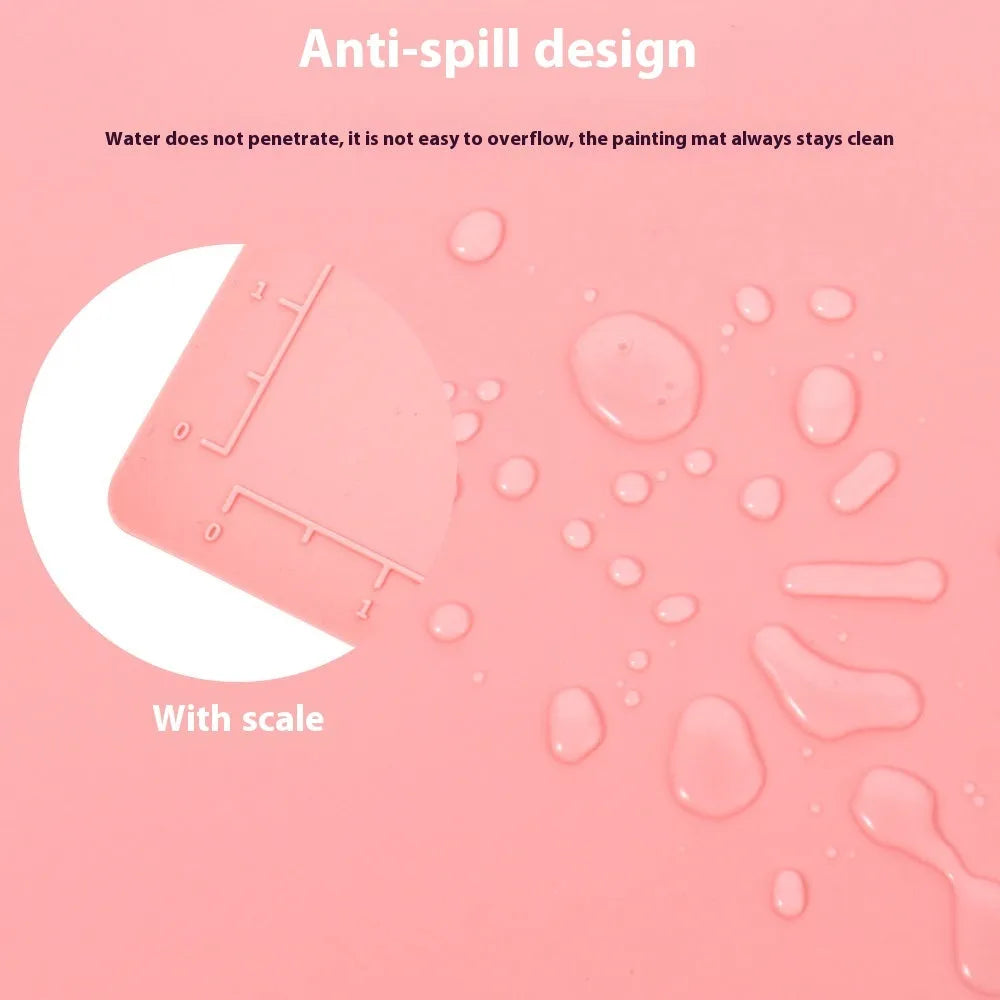 Light blue silicone painting mat measuring 50 by 40 centimetres with two round paint wells.