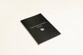 Black A5 hardback dream journal notebook open on a lined page and a dot grid page.