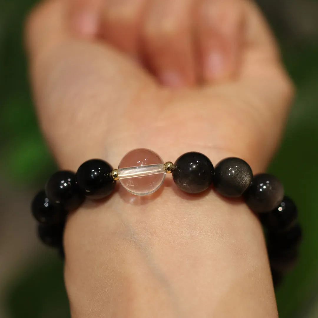 Chinese style geometric crystal bracelet with cat eye obsidian stone and auspicious patterns.