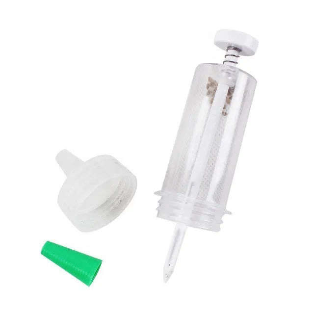 A 12cm long, 3cm diameter plastic mini garden seeder tool for dispensing seeds into pots.